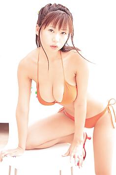 Rio Natsume posing in sexy orange bikini her natural breasts